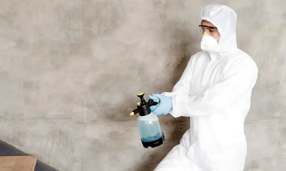 man disinfecting stairs